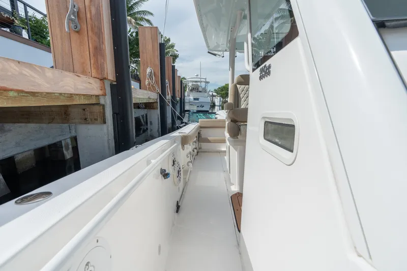Slide: The Image of 2020 Everglades 355 Center Console boat docked, showcasing sleek design and spacious deck. - 21