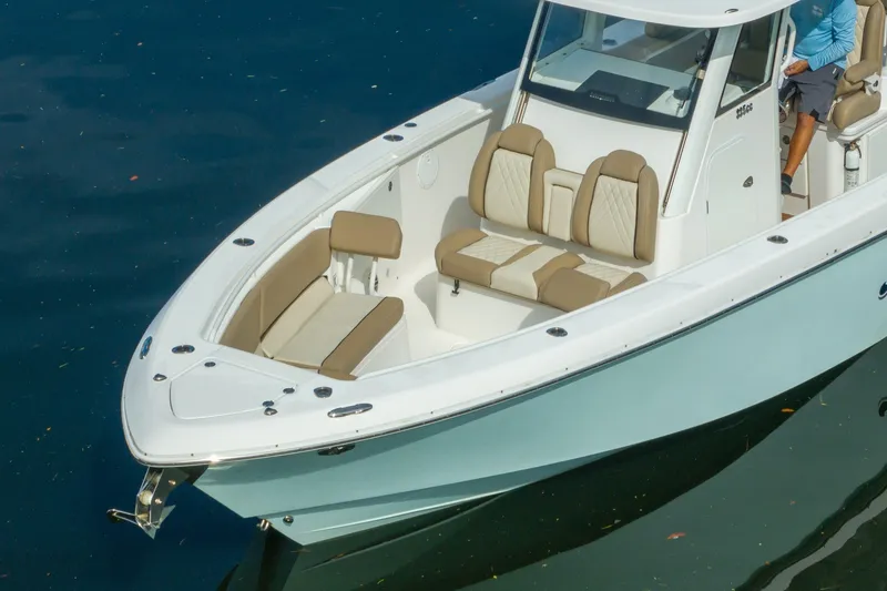 Slide: The Image of 2020 Everglades 355 Center Console boat with beige seating on calm water. - 7