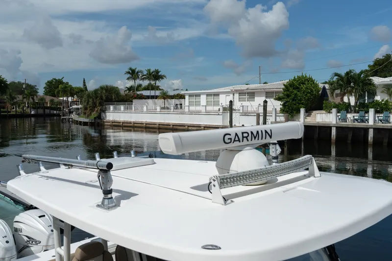Slide: The Image of 2020 Everglades 355 Center Console boat with Garmin radar, docked near waterfront homes. - 28