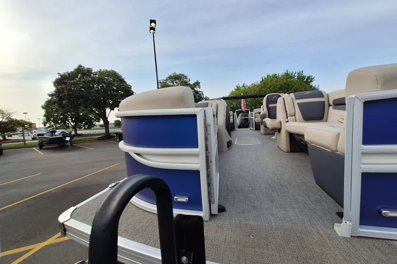 Slide: The Image of 2023 Barletta Cabrio 22QC pontoon boat with spacious seating, parked outdoors. - 5