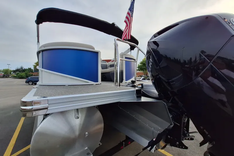 Slide: The Image of 2023 Barletta Cabrio 22QC pontoon boat with outboard motor and American flag. - 7