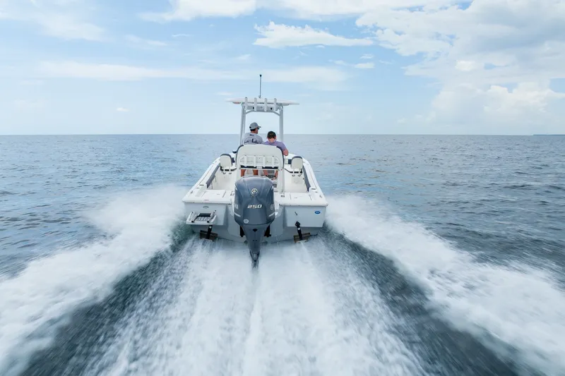 Slide: The Image of 2024 Tidewater 2300 Carolina Bay boat cruising on open water under a clear sky. - 14