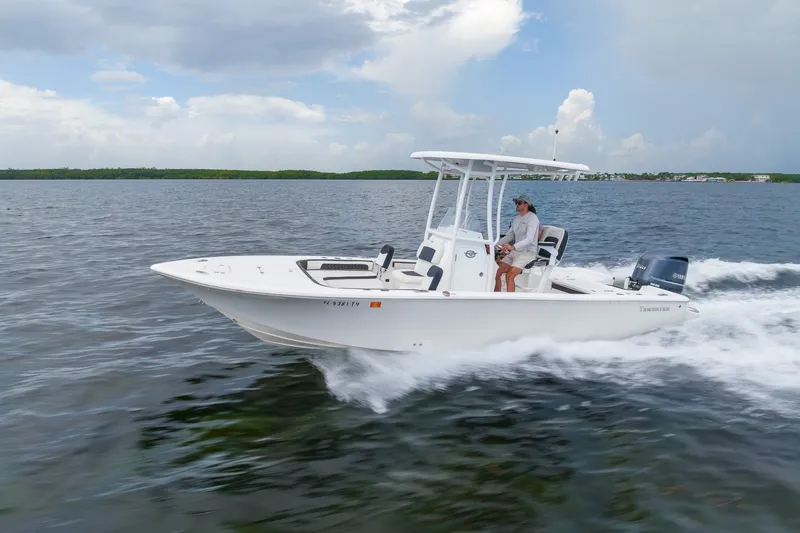 Slide: The Image of 2024 Tidewater 2300 Carolina Bay boat cruising on open water under cloudy skies. - 15