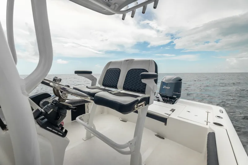 Slide: The Image of 2024 Tidewater 2300 Carolina Bay boat interior with ocean view and seating. - 18