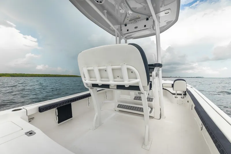 Slide: The Image of 2024 Tidewater 2300 Carolina Bay boat interior with seating, on open water. - 19