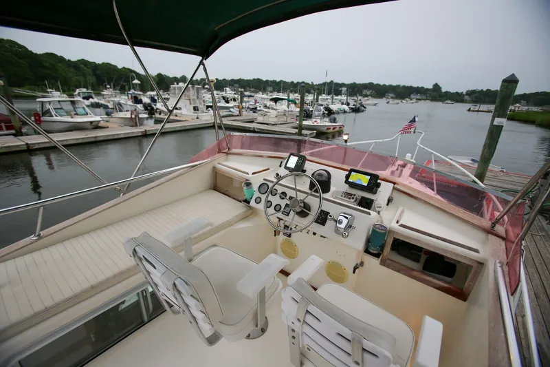 Slide: The Image of Cockpit view of 1995 Nauset 28 Bridgedeck boat docked at marina. - 16