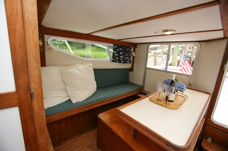 Slide: The Image of Cozy interior of 1995 Nauset 28 Bridgedeck with seating, table, and decor. - 22