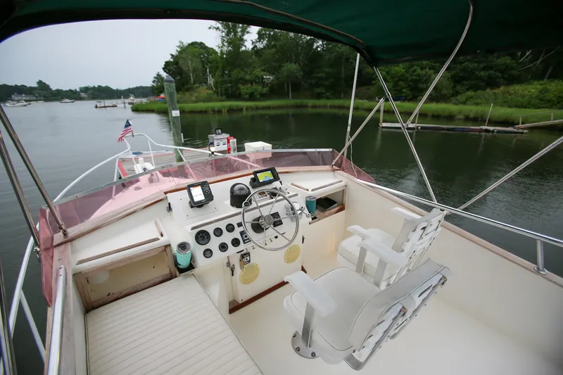 Slide: The Image of Cockpit view of 1995 Nauset 28 Bridgedeck boat with steering wheel and navigation equipment. - 15