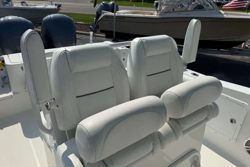 Slide: The Image of 2015 Sea Hunt Gamefish 30CB boat with white cushioned seats and dual engines. - 10