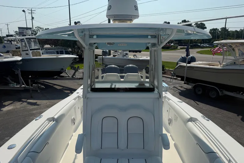 Slide: The Image of 2015 Sea Hunt Gamefish 30CB boat, white interior, docked at marina with other boats. - 5