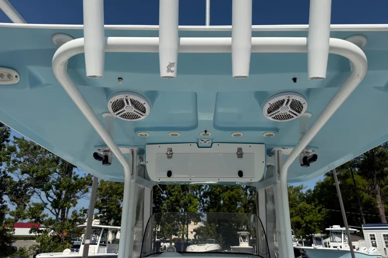 Slide: The Image of 2015 Sea Hunt Gamefish 30CB boat with blue T-top and mounted speakers. - 9
