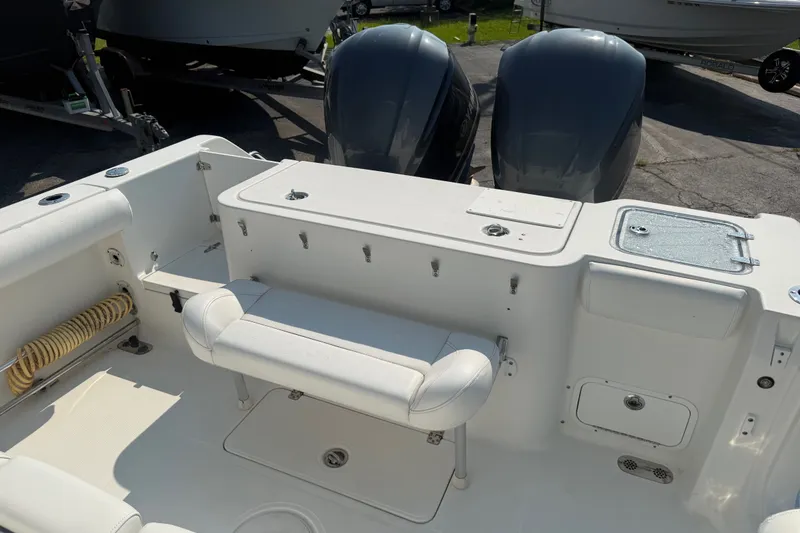 Slide: The Image of 2015 Sea Hunt Gamefish 30CB boat interior with dual engines and seating area. - 12