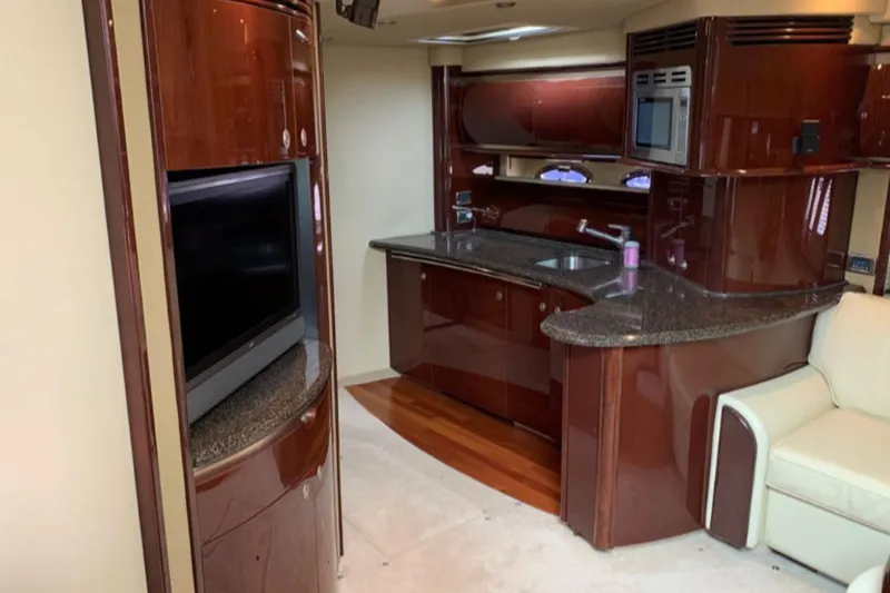 Slide: The Image of Luxurious interior of 2007 Sea Ray 52 Sundancer yacht with modern kitchen and entertainment area. - 9