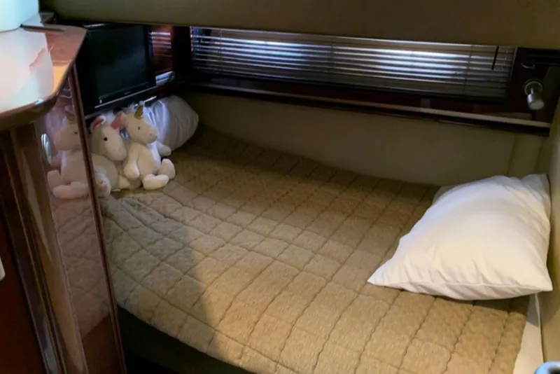 Slide: The Image of Cozy cabin bed with unicorn plush toys on a 2007 Sea Ray 52 Sundancer yacht. - 17