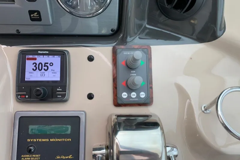 Slide: The Image of Control panel of a 2007 Sea Ray 52 Sundancer with navigation and system monitors. - 6