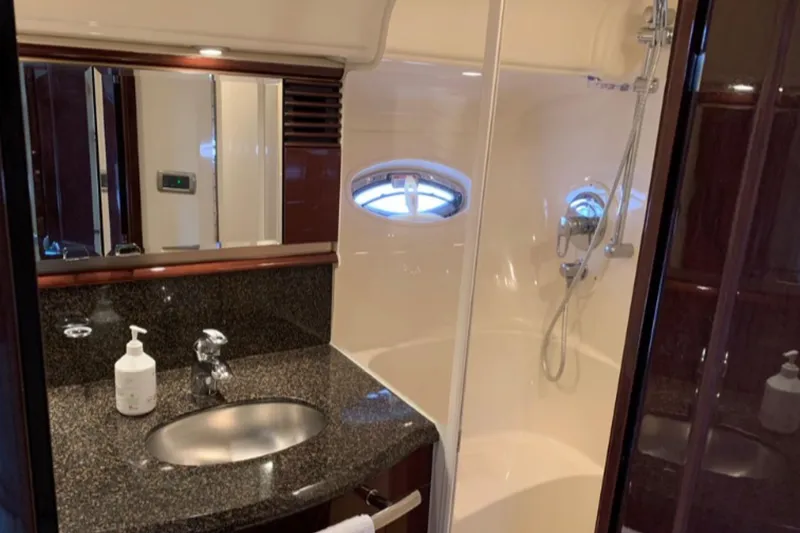 Slide: The Image of Luxurious bathroom in 2007 Sea Ray 52 Sundancer yacht with granite countertop and shower. - 14
