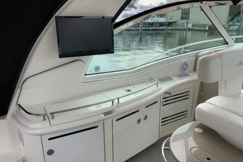 Slide: The Image of 2007 Sea Ray 52 Sundancer yacht interior with TV and seating by the water. - 3