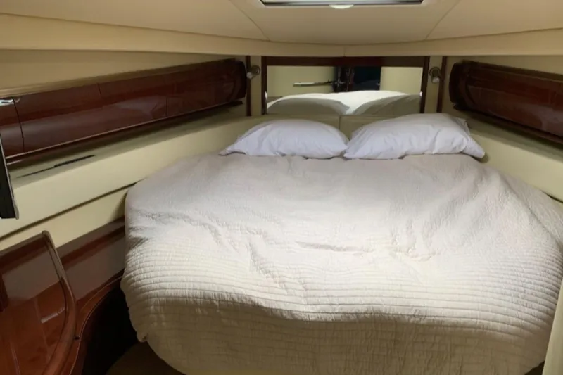 Slide: The Image of Luxurious cabin interior of 2007 Sea Ray 52 Sundancer yacht with cozy bed and elegant wood finish. - 16