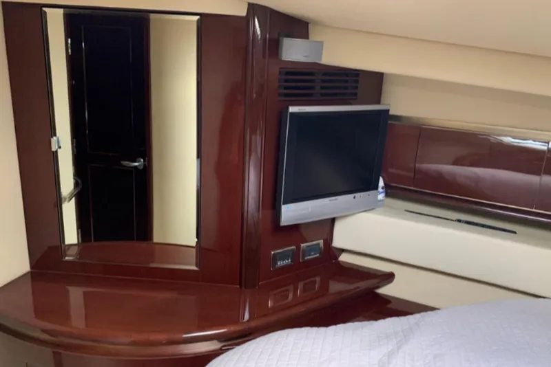 Slide: The Image of Interior of 2007 Sea Ray 52 Sundancer yacht with TV and wooden cabinetry. - 15