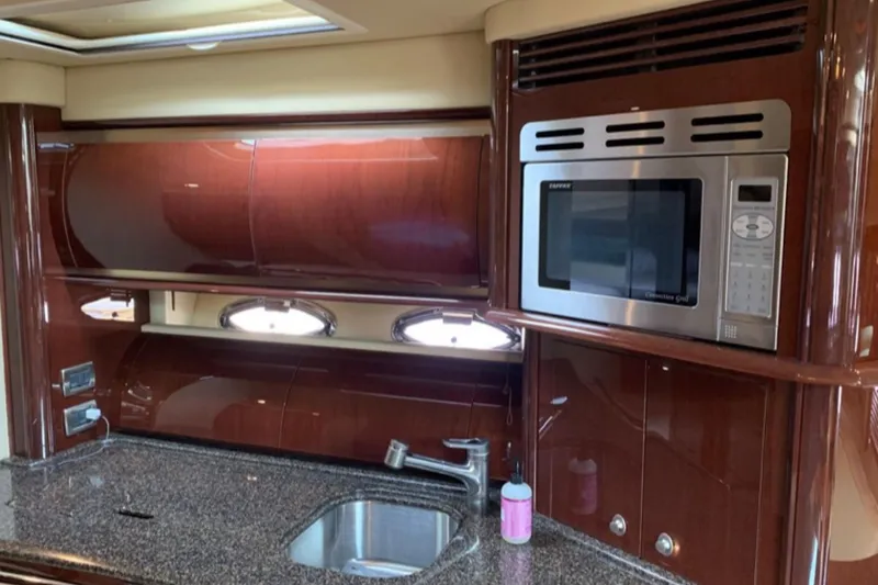 Slide: The Image of Luxurious 2007 Sea Ray 52 Sundancer yacht kitchen with microwave and sleek cabinetry. - 11