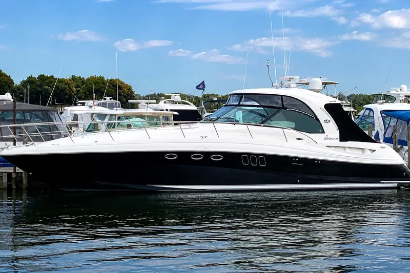 The Image of 2007 Sea Ray 52 Sundancer yacht docked at marina under blue sky. - 0