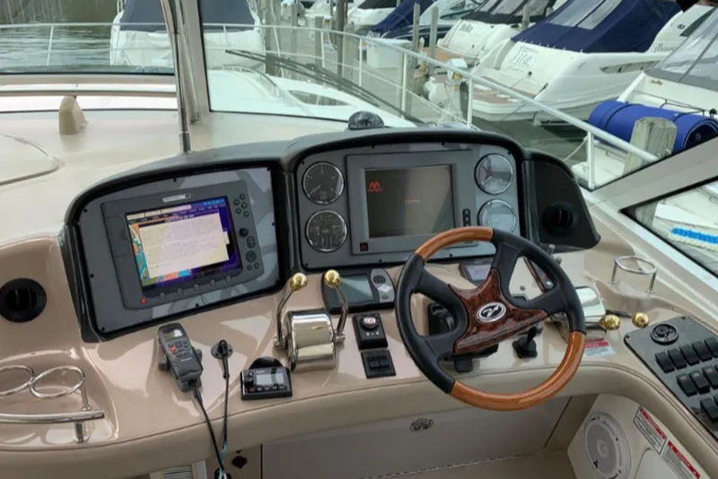 Slide: The Image of Helm of 2007 Sea Ray 52 Sundancer with navigation equipment and wooden steering wheel. - 5