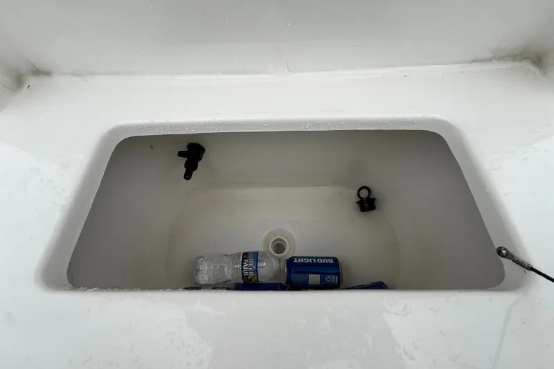 Slide: The Image of Open storage compartment on 2025 Sea Hunt BX25FS boat with drinks inside. - 32