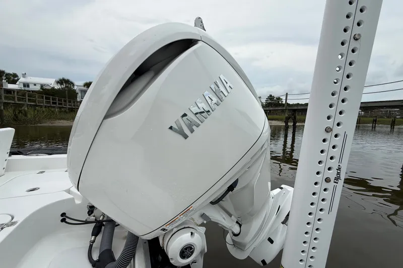 Slide: The Image of 2025 Sea Hunt BX25FS boat with Yamaha outboard motor on calm water. - 7