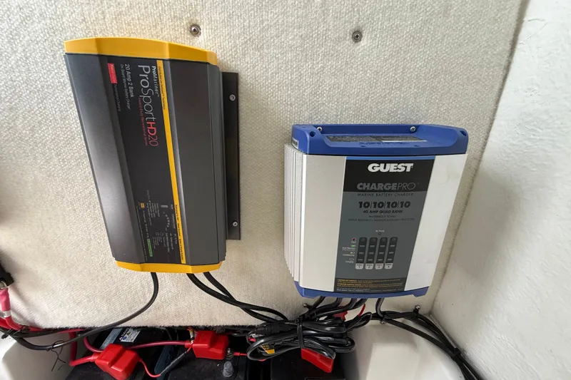 Slide: The Image of Marine battery chargers on a 2025 Sea Hunt BX25FS boat, featuring ProSport HD20 and Guest ChargePro. - 37