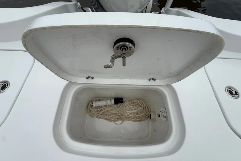 Slide: The Image of Open storage compartment on 2025 Sea Hunt BX25FS boat with rope inside. - 29