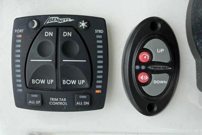 Slide: The Image of Control panels for Bennett trim tabs and Power-Pole on a 2025 Sea Hunt BX25FS boat. - 13