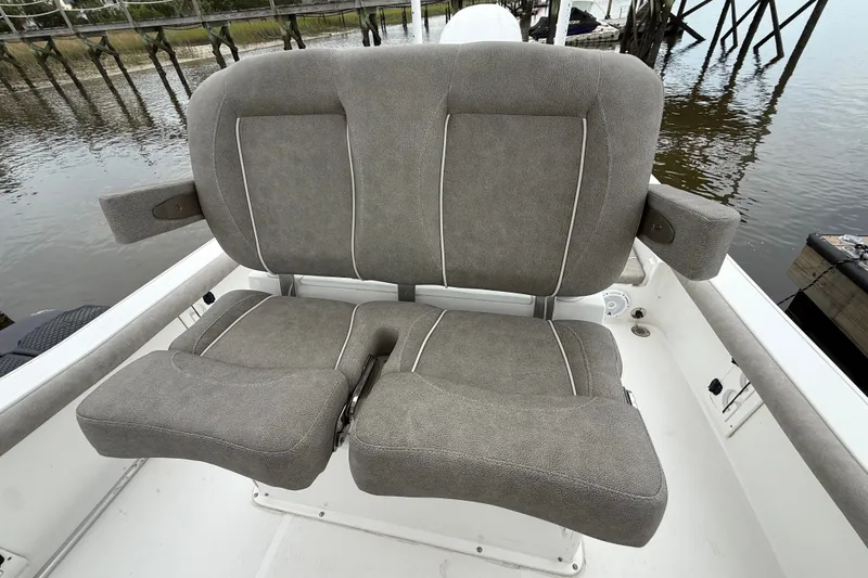 Slide: The Image of Gray cushioned seats on a 2025 Sea Hunt BX25FS boat, dockside view. - 16