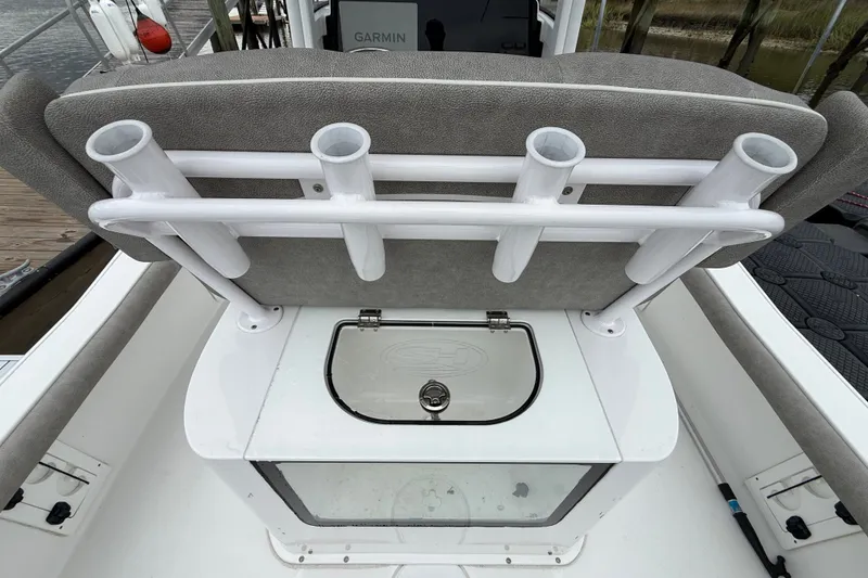 Slide: The Image of 2025 Sea Hunt BX25FS boat with rod holders and livewell on deck. - 18