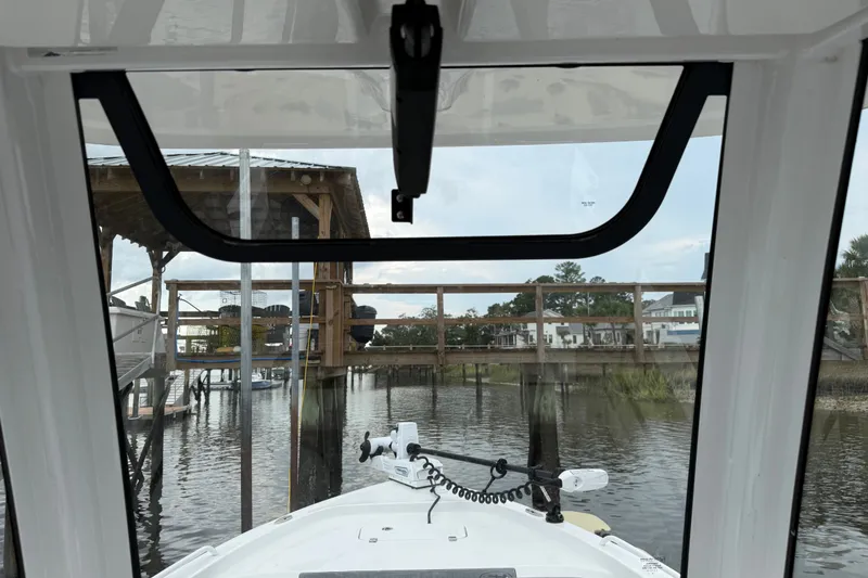 Slide: The Image of Interior view from a 2025 Sea Hunt BX25FS boat docked at a marina. - 21