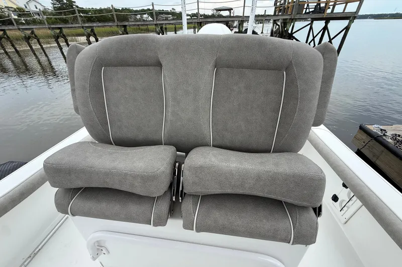 Slide: The Image of Gray cushioned seats on a 2025 Sea Hunt BX25FS boat by the water. - 17