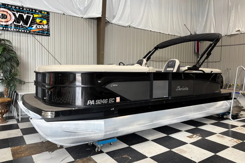 The Image of 2023 Barletta Cabrio 22QC pontoon boat in showroom, black exterior, sleek design. - 0
