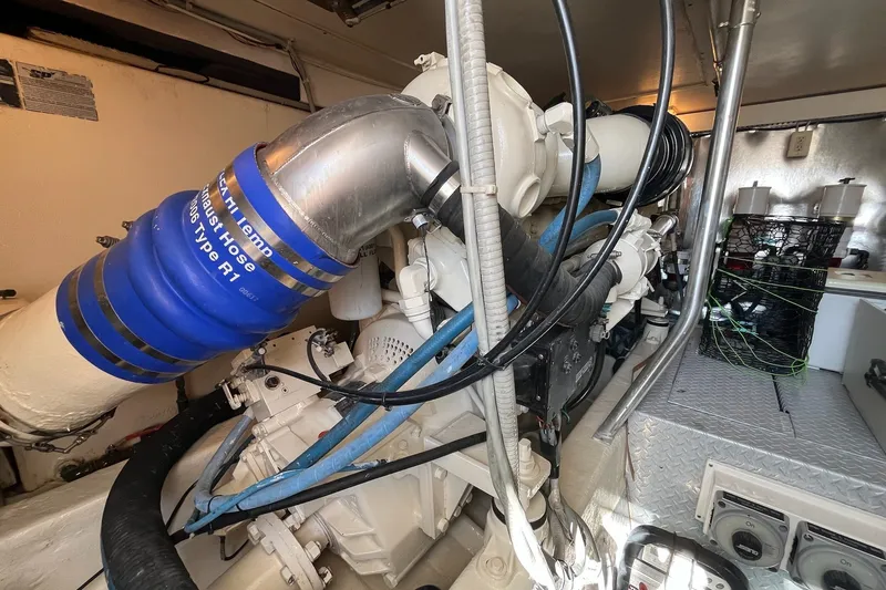 Slide: The Image of Engine room of a 2004 Ocean Yacht 52 Super Sport, featuring complex machinery and components. - 35