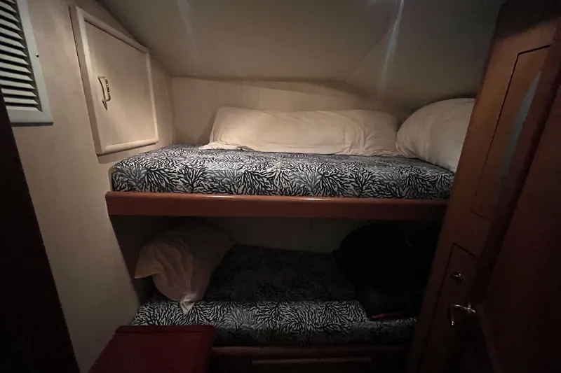 Slide: The Image of Bunk beds in 2004 Ocean Yacht 52 Super Sport cabin with patterned bedding. - 13