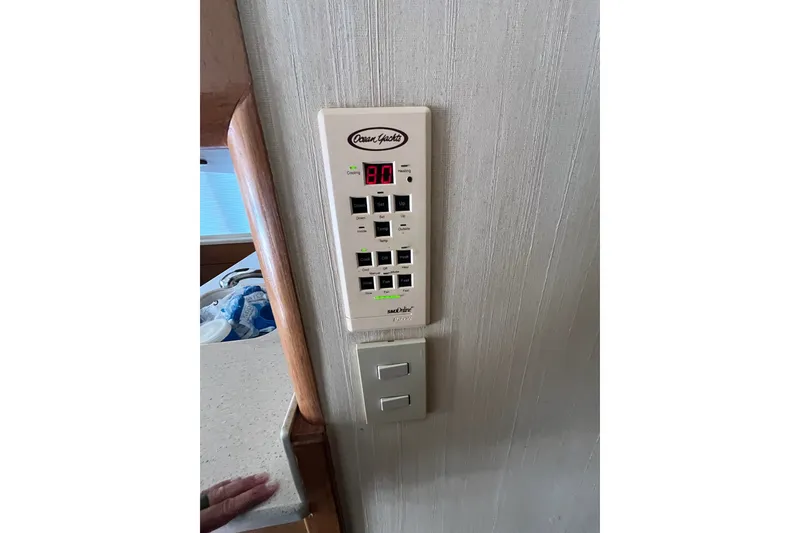 Slide: The Image of Control panel inside a 2004 Ocean Yacht 52 Super Sport, displaying temperature settings. - 12