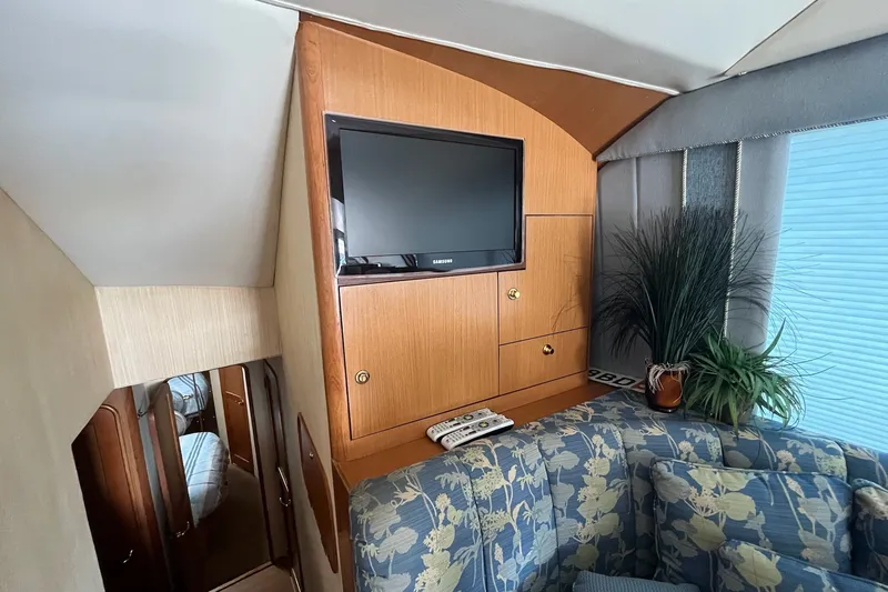 Slide: The Image of Interior of 2004 Ocean Yacht 52 Super Sport with TV, floral sofa, and decor. - 9