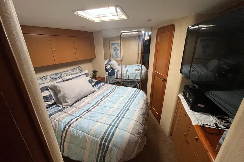 Slide: The Image of Luxurious bedroom interior of 2004 Ocean Yacht 52 Super Sport with cozy bedding and modern amenities. - 14