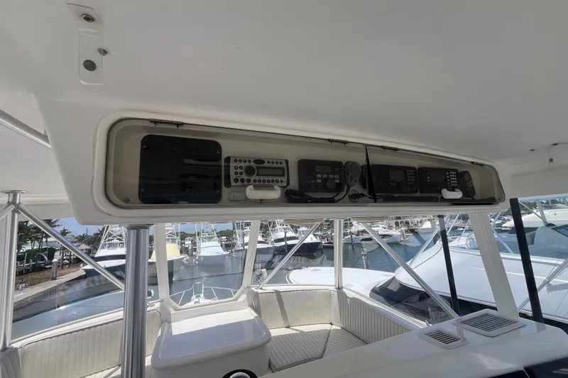 Slide: The Image of 2004 Ocean Yacht 52 Super Sport helm with electronic controls and marina view. - 28