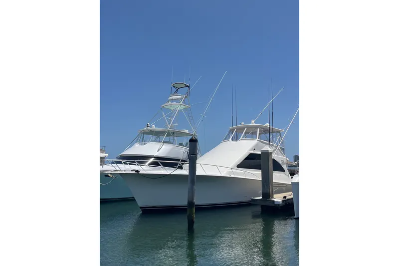 Slide: The Image of 2004 Ocean Yacht 52 Super Sport docked under clear blue sky. - 1