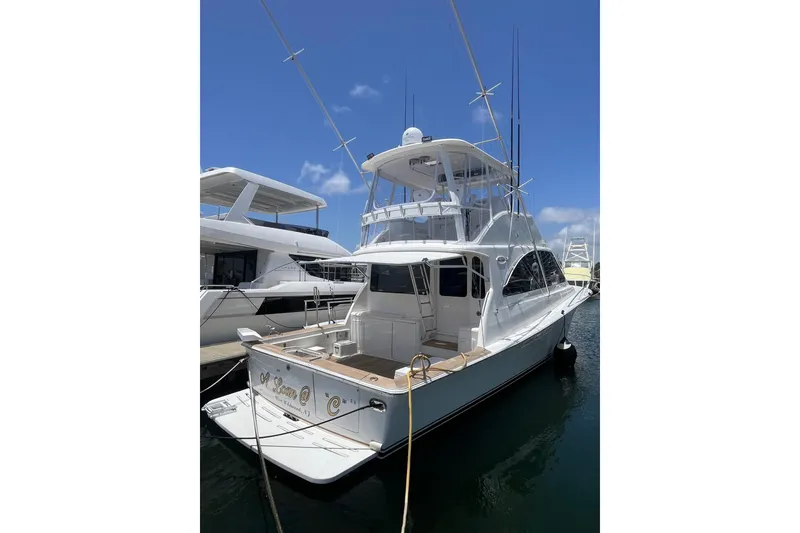 Slide: The Image of 2004 Ocean Yacht 52 Super Sport docked at marina under clear blue sky. - 19