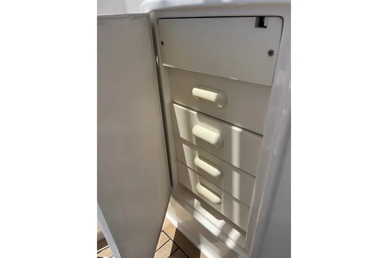 Slide: The Image of White storage cabinet with drawers on a 2004 Ocean Yacht 52 Super Sport. - 23