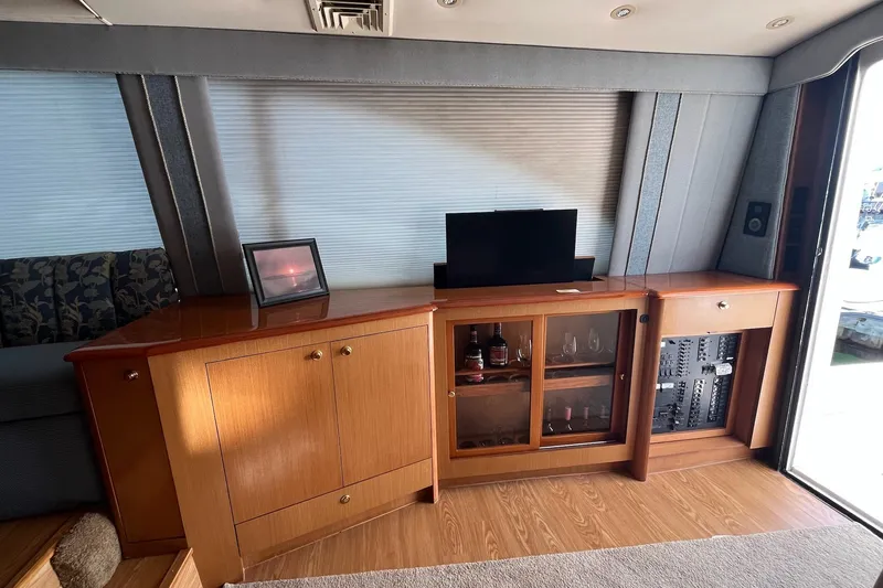 Slide: The Image of Interior of 2004 Ocean Yacht 52 Super Sport with wooden cabinets and a small TV. - 4