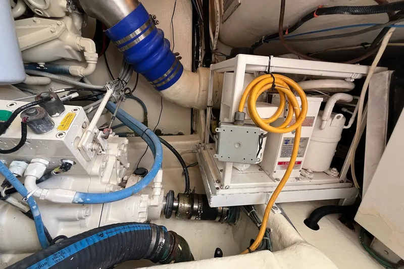 Slide: The Image of Engine room of a 2004 Ocean Yacht 52 Super Sport with visible machinery and cables. - 34