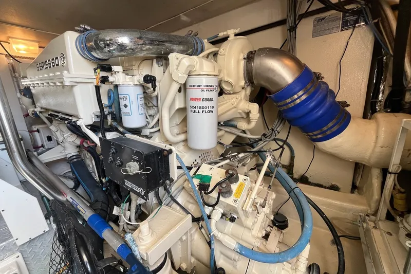 Slide: The Image of Engine room of a 2004 Ocean Yacht 52 Super Sport, showcasing detailed machinery components. - 33