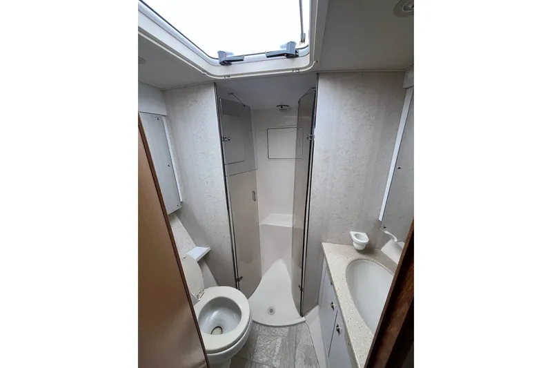 Slide: The Image of Bathroom interior of 2004 Ocean Yacht 52 Super Sport with shower, toilet, and sink. - 16