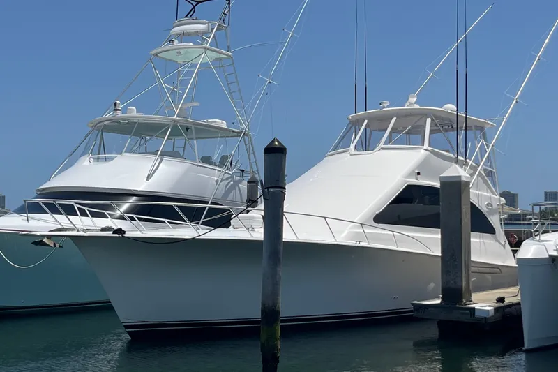 Slide: The Image of 2004 Ocean Yacht 52 Super Sport docked at marina under clear blue sky. - 0